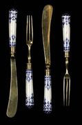 A rare set of twelve 18th century French Saint Cloud porcelain and gilt metal kn