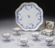 AN 18TH CENTURY SEVRES SOFT-PASTE PORCELAIN SHAPED TRAY AND FIVE CUPS 

