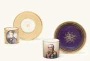 A NYMPHENBURG APRICOT-GROUND CABINET CUP AND A SAUCER AND A MEISSEN (MARCOLINI) 